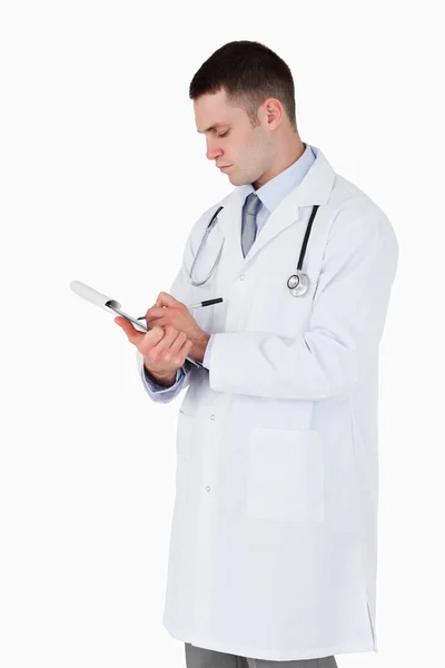 Doctor carefully taking notes — Stock Photo, Image