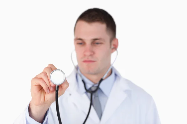 Close up of doctor looking at this stethoscope — Stock Photo, Image