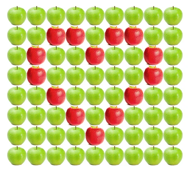 Green wet apples with red apples in heart shape in between — Stock Photo, Image