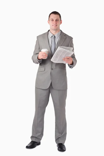 Portrait of a businessman holding a newspaper and a cup of coffe — Stock Photo, Image
