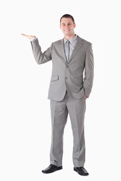 Portrait of a smiling businessman presenting something — Stock Photo, Image