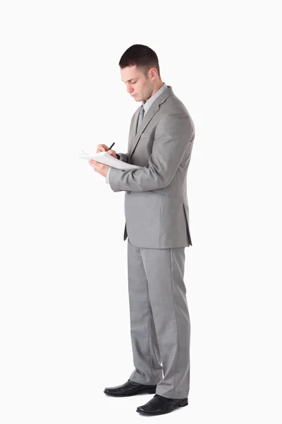 Portrait of a serious businessman taking notes — Stock Photo, Image