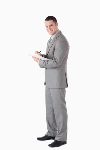 Portrait of a young businessman taking notes — Stock Photo, Image