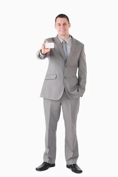 Portrait of a smiling businessman showing a business card — Stock Photo, Image