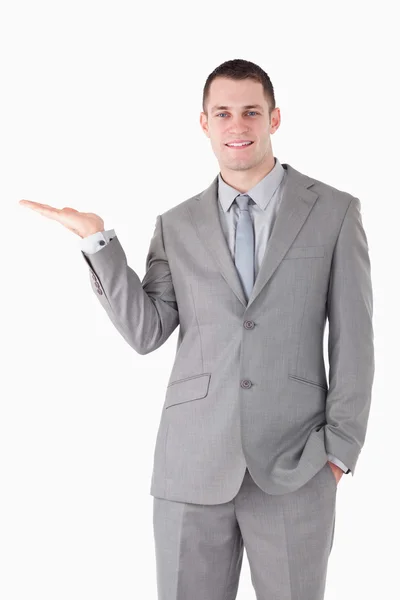 Portrait of a young businessman holding something — Stock Photo, Image