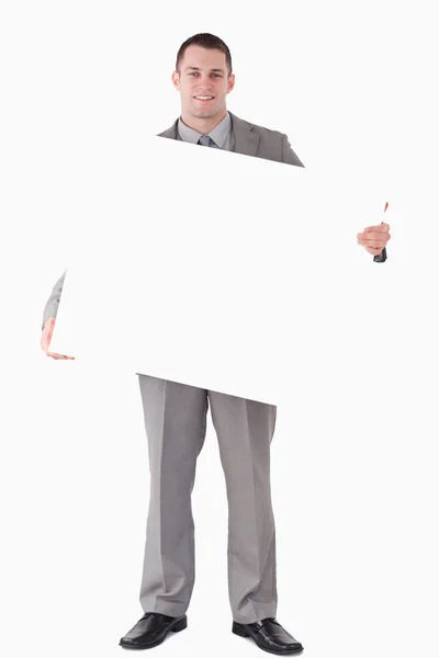 Portrét podnikatel drží prázdného panelu — Stock fotografie