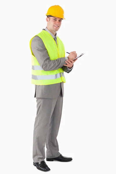 Portrait of a smiling contractor taking notes — Stock Photo, Image