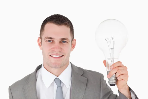 Empresário segurando uma lâmpada — Fotografia de Stock
