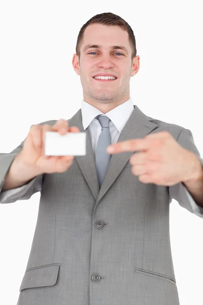 Portrait of a businessman pointing at a blank business card — Stock Photo, Image