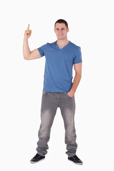 Portrait of a smiling man pointing at something — Stock Photo, Image