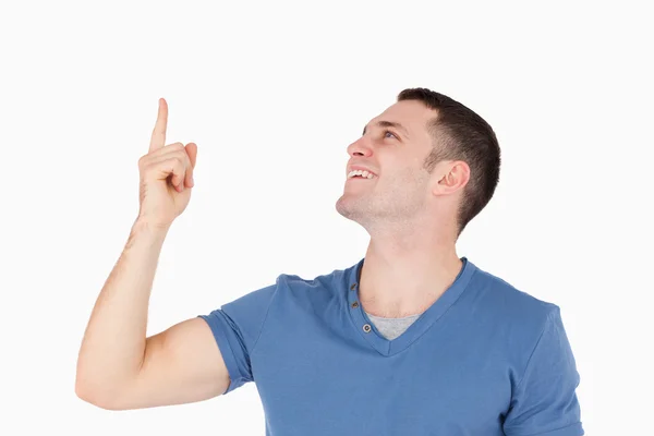 Smiling man pointing at something — Stock Photo, Image