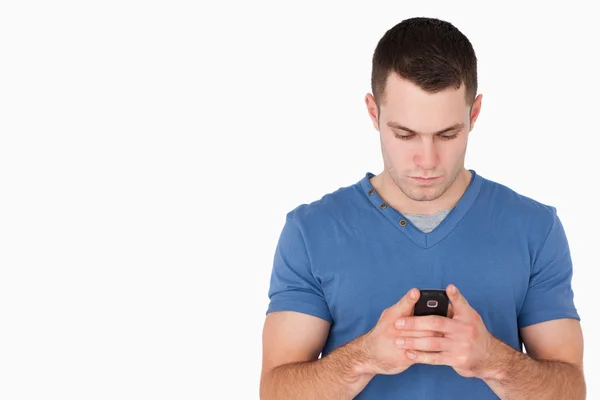 Young man sending text messages — Stock Photo, Image