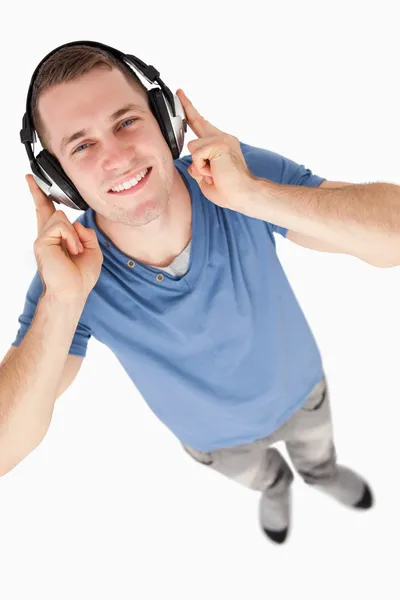 Portrait of a young man listening to music — Stock Photo, Image