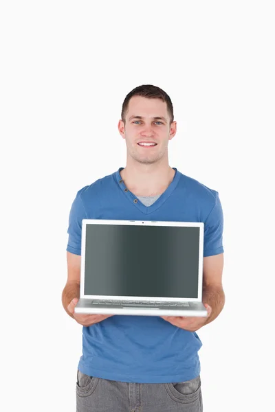 Portrait of a young man holding a laptop — Stock Photo, Image