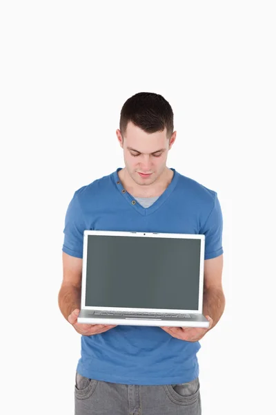 Porträtt av en ung man tittar på en bärbar dator — Stockfoto