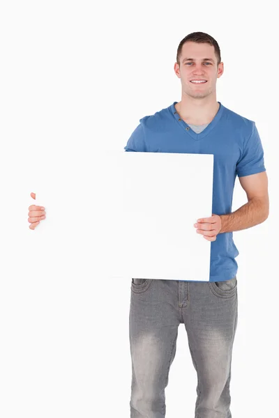 Portrait of a young man holding a blank panel — Stock Photo, Image
