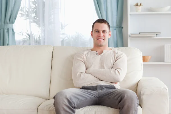 Человек, сидящий на диване — стоковое фото