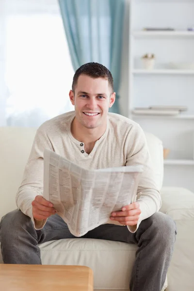 Bir gazete tutan gülümseyen bir adam portresi — Stok fotoğraf