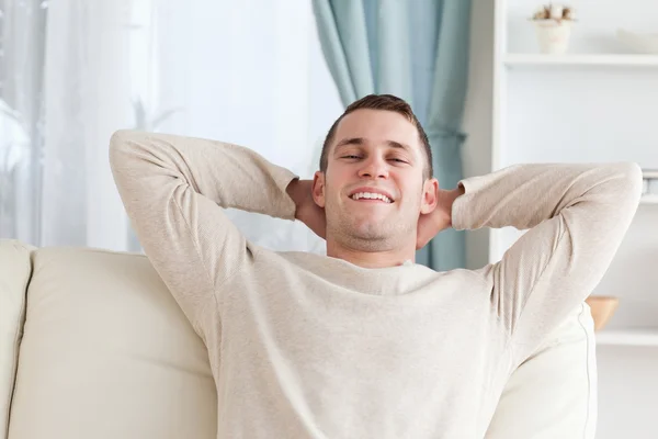 Man relaxing on a sofa — Stock Photo, Image