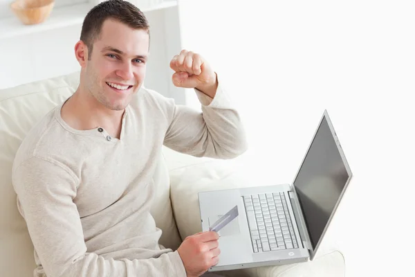 stock image Young man shopping online with the fist up