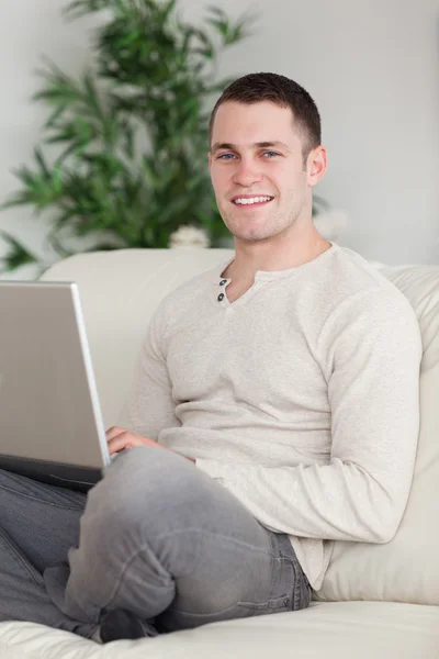 Porträtt av en lycklig man koppla av med en bärbar dator — Stockfoto