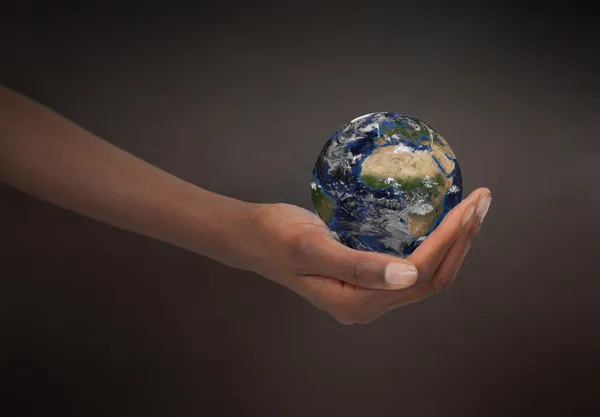 Feminine hand holding the Earth — Stock Photo, Image