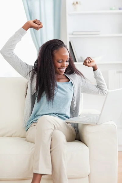 Woman cheering at her laptop — Stock Photo, Image
