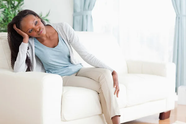 Woman on sofa in thoughts — Stock Photo, Image