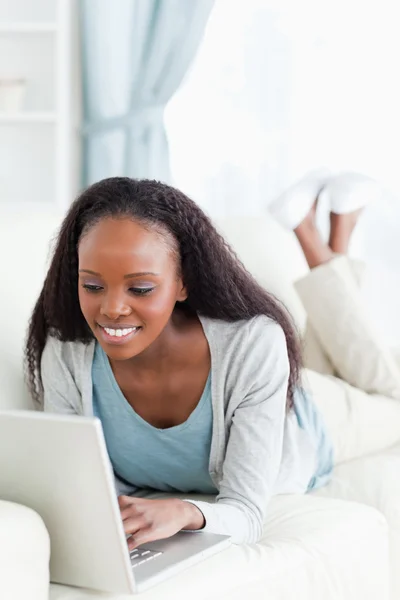 Close up of woman on sofa surfing the internet — Stock Photo, Image
