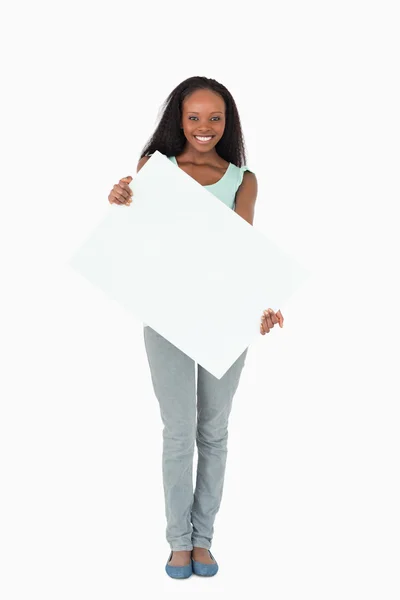 Woman holding placeholder on white background — Stock Photo, Image