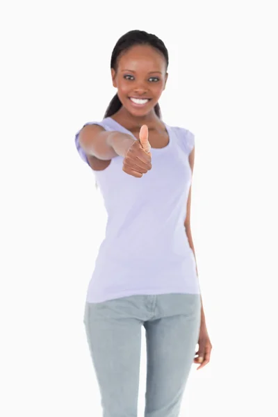 Close up of thumb up being given by woman on white background — Stock Photo, Image