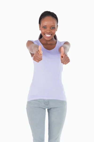 Close up of thumbs up being given by woman on white background — Stock Photo, Image