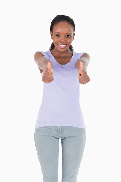 Close up of woman giving thumbs up on white background — Stock Photo, Image