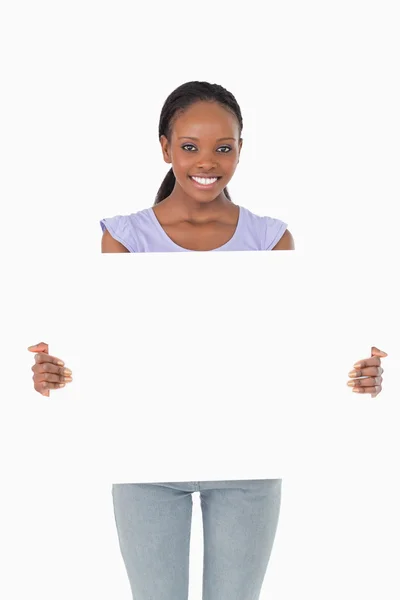 Close up of woman presenting placeholder on white background — Stock Photo, Image