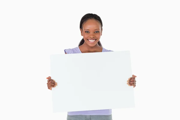 Woman holding placeholder in her hands on white background — Stock Photo, Image