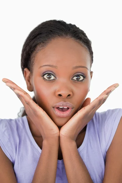 Close up of frightened woman against a white background — Stock Photo, Image