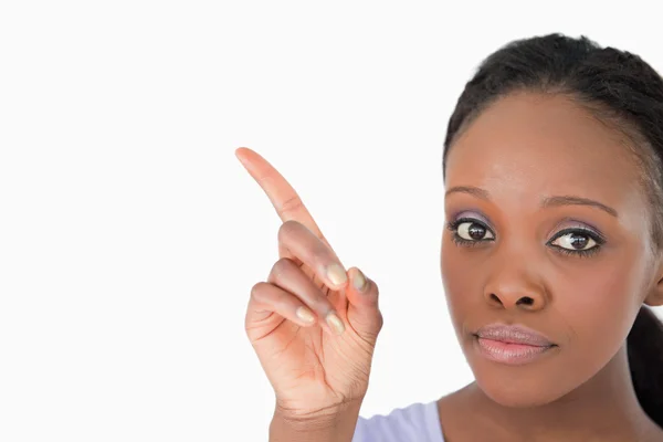 Close up of woman showing something next to her on white backgro — Stock Photo, Image