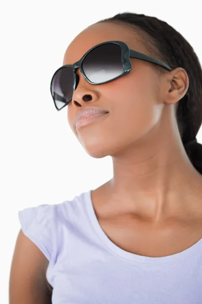 Close up of woman wearing her sunglasses against a white backgro — Stock Photo, Image