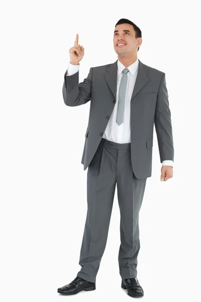 Businessman pointing and looking upwards — Stock Photo, Image