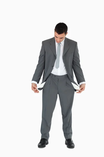 Businessman looking at empty pockets — Stock Photo, Image