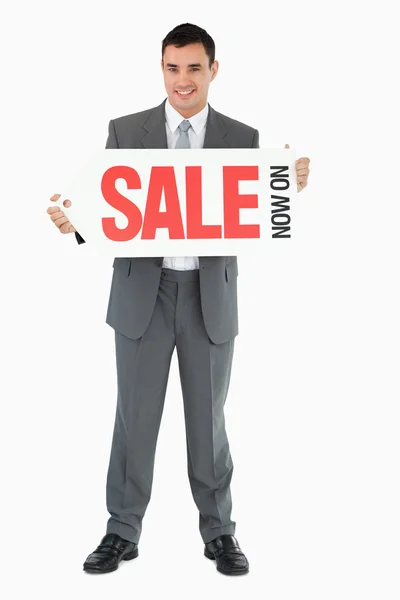 Businessman with signboard — Stock Photo, Image