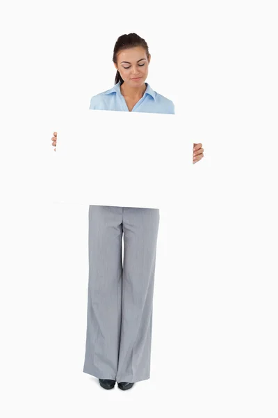 Businesswoman looking at the sign she is presenting — Stock Photo, Image