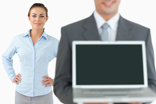 Business team presenting laptop — Stock Photo, Image