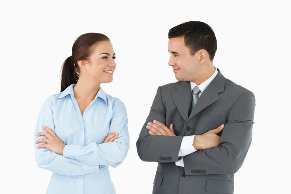 Business partners with arms folded looking at each other — Stock Photo, Image