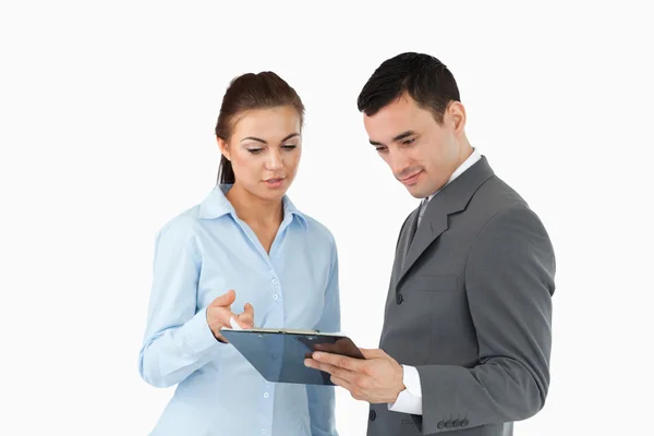 Business partners taking a look at the clipboard — Stock Photo, Image