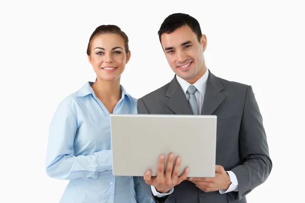Partenaires commerciaux souriants avec ordinateur portable — Photo
