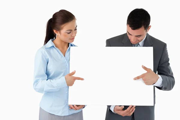 Business partners pointing at sign they are presenting — Stock Photo, Image