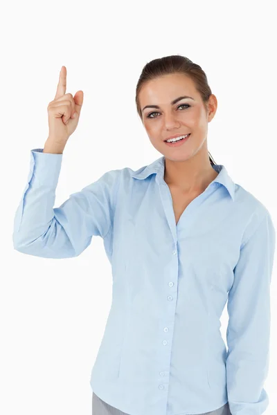 Smiling businesswoman pointing upwards — Stock Photo, Image