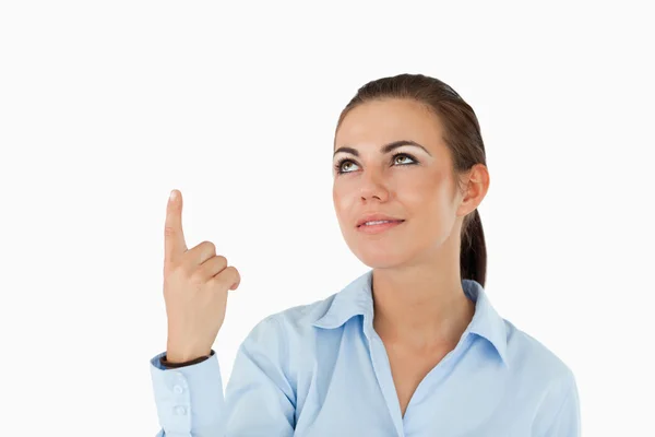 Businesswoman pointing with her finger upwards — Stock Photo, Image