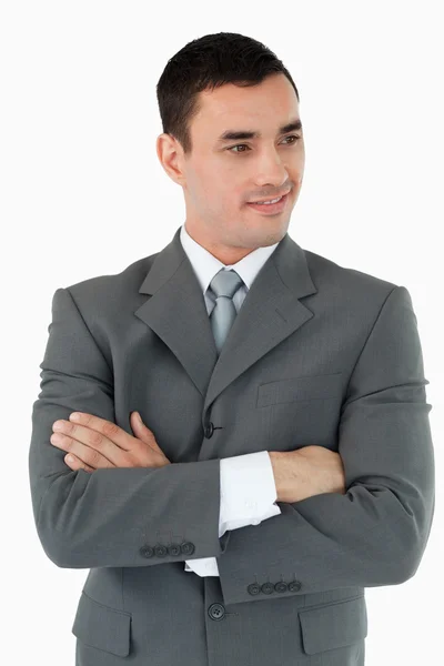 Businessman with arms folded looking to the side — Stock Photo, Image